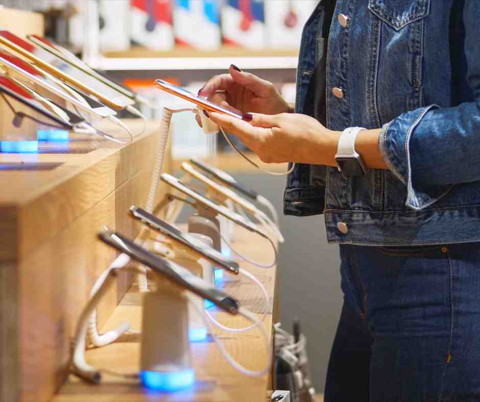 woman choosing smartphone in store