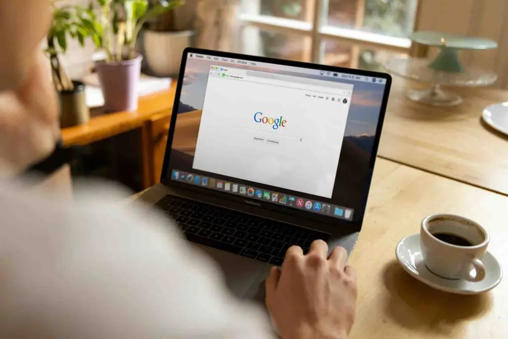 the opened laptop with google logo on its desktop